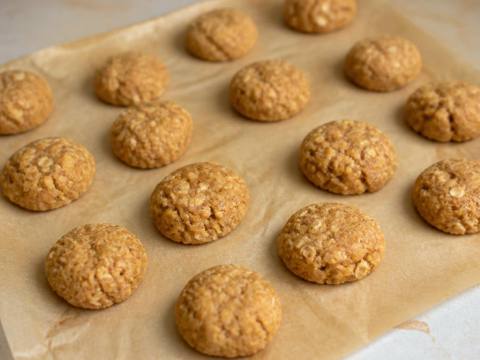Small homemade peanut butter and banana oat dog treat bites on baking parchment