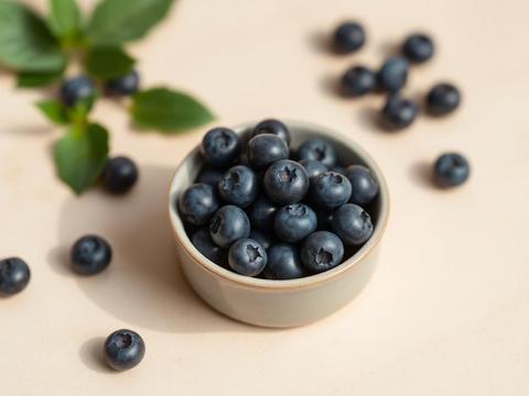Fresh blueberries in a small ceramic bowl